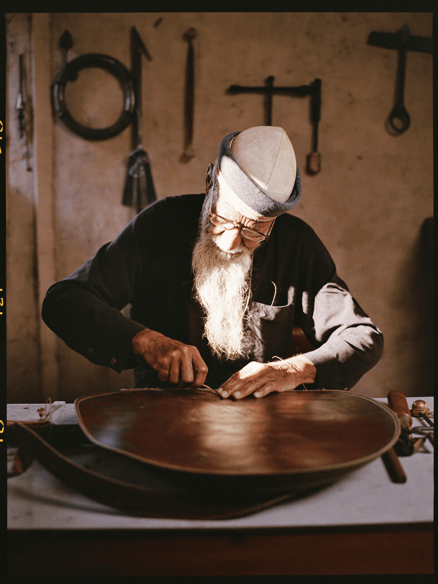 A master Muallem hand-stitching a LumaFes backpack in Fes